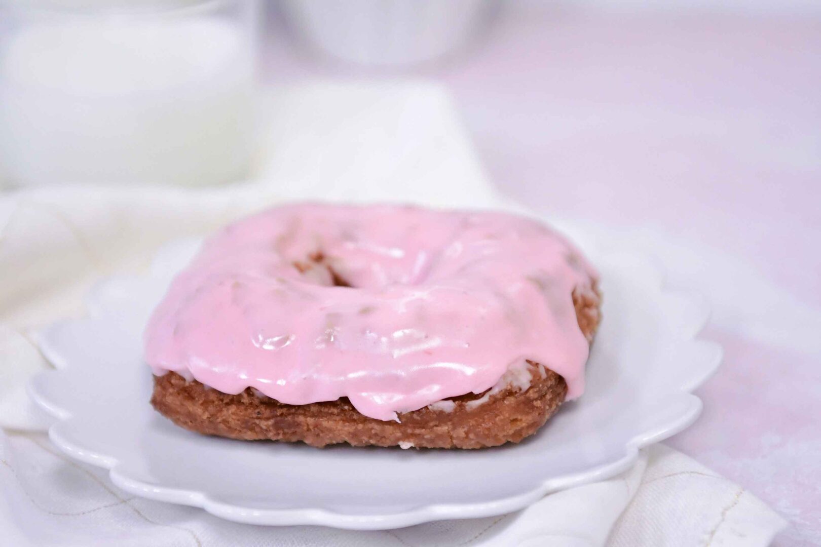 donut covered with a pink caramel topping