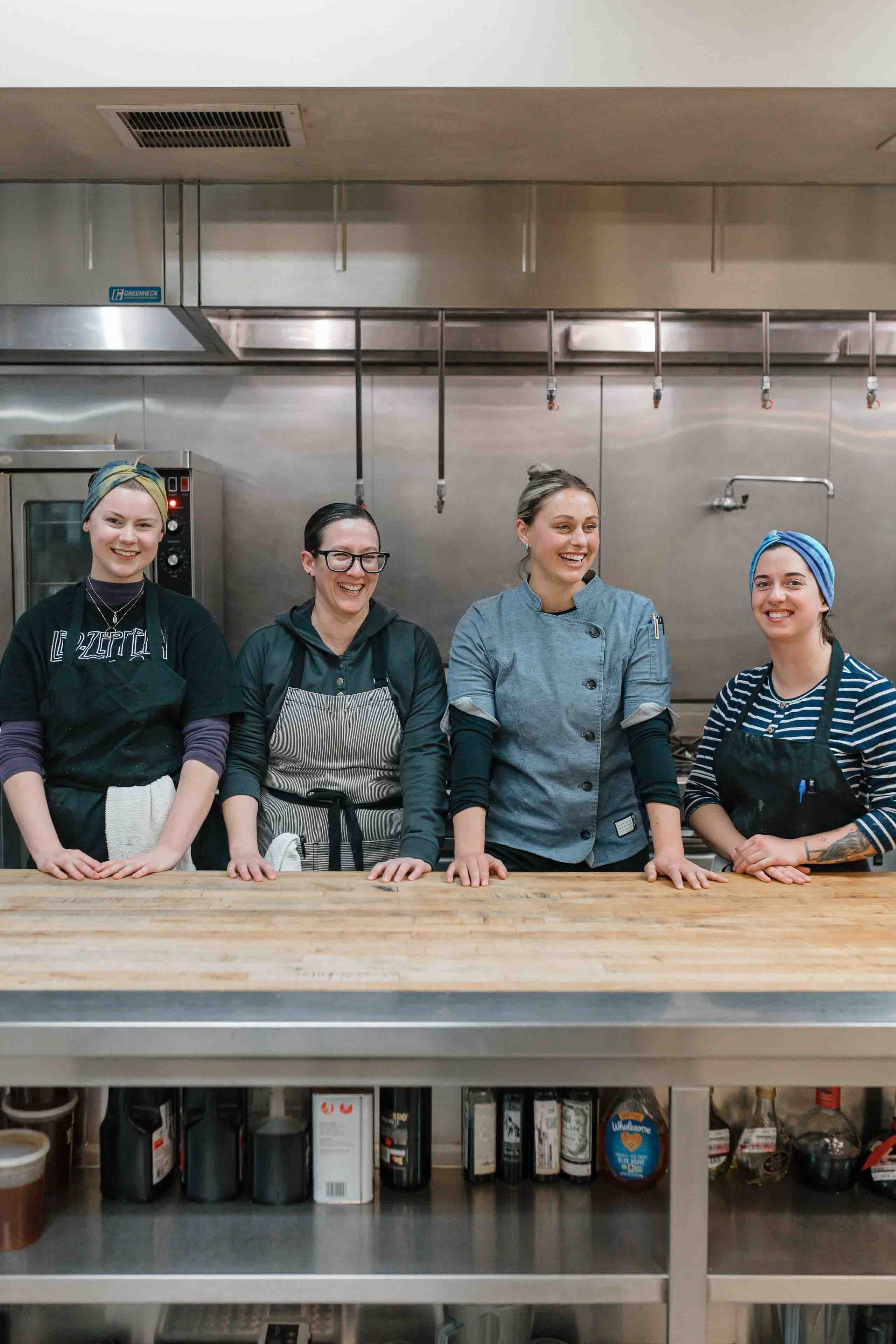 Four Women Smiling In The Kitchen Of Dirty Girl Donuts
